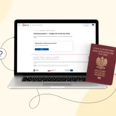 Czy można złożyć wniosek o paszport za kogoś? Strona gov.pl wyjaśnia procedurę. Obok laptopa leży polski paszport.