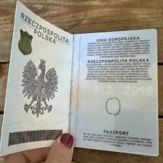 Otwarty polski paszport z godłem orła. Czy emeryci mają zniżkę na paszport? Informacje o paszporcie w języku polskim i angielskim.
